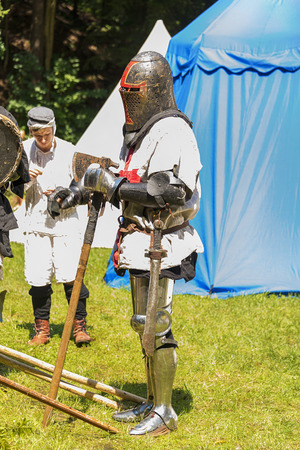 Lviv , Ukraine â august , 04, 2018:  Festival of medieval history and knight duels. A participant of the festival in knight armor prepares for a duel in the city park of the city of Lvivのeditorial素材