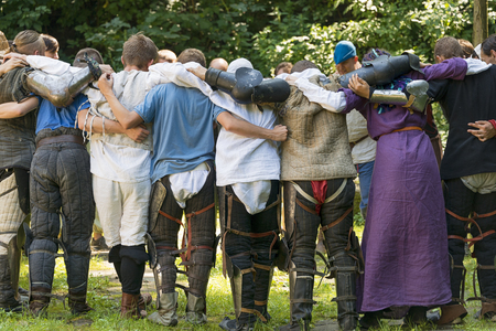 Lviv , Ukraine â august , 04, 2018:  Festival of medieval history and knight duels in the city park in Lviv. A group of participants meditating before the fightのeditorial素材