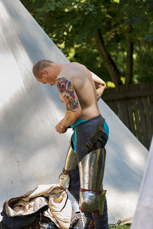 Lviv , Ukraine â august , 04, 2018:  Festival of medieval history and knight duels in the city park in Lviv. Unknown participant in the festival wears knightly armor.のeditorial素材