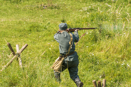 Lviv, Ukraine â  September,03, 2018: Military historical reconstruction is dedicated to the centenary of the proclamation of the Western Ukrainian People's Republic in the  park of Lviv city.Sagittarius fires on the enemyのeditorial素材