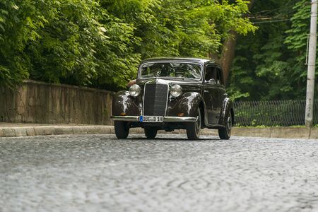 Lviv, Ukraine - June 2, 2019: Old retro car Mercedes Benz 170 S-S with its owner and  unknown passenger taking participation in race Leopolis grand prix 2019, Ukraine.のeditorial素材