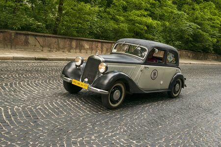 Lviv, Ukraine - June 2, 2019: Old retro car Mercedes- Benz w136 170v (1941)  with its owner and  unknown passenger taking participation in race Leopolis grand prix 2019, Ukraine.のeditorial素材