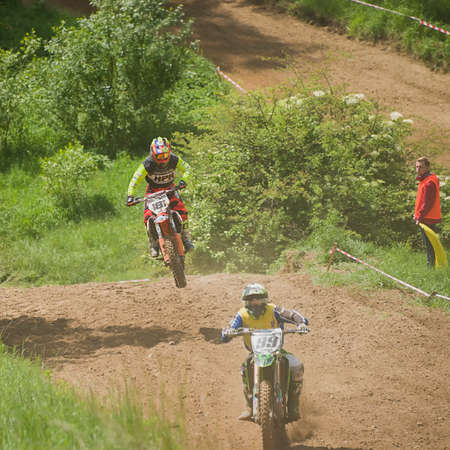 Lviv, Ukraine - May 20 2018: Open Cup of Lviv on the motocross track Mayorovka. Unknown motorcycle racer overcomes motocross track in the fight for the championship.のeditorial素材