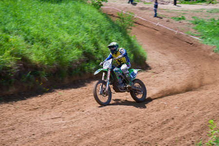 Lviv, Ukraine - May 20 2018: Open Cup of Lviv on the motocross track Mayorovka. Unknown motorcycle racer overcomes motocross track in the fight for the championship.のeditorial素材