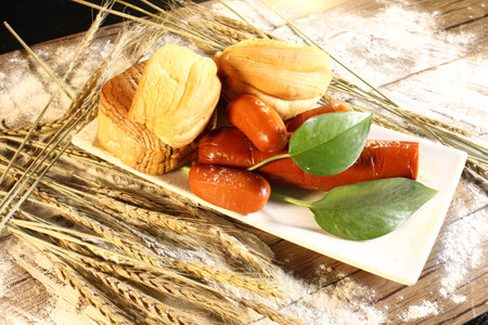 bread and sausages on a plateの写真素材