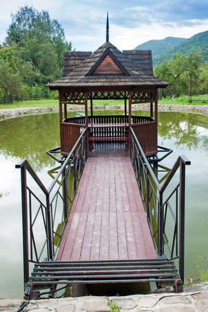 Wooden gazebos on shore of lake in Ukrainian Carpathians.の写真素材