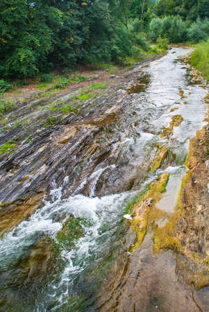 Mountain river flowing through the green forest.の写真素材