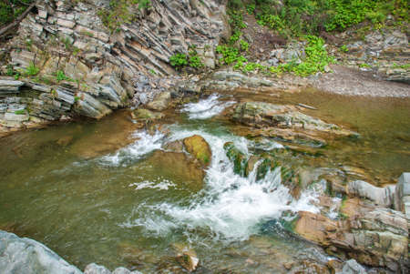 Mountain river flowing through the green forest.の写真素材