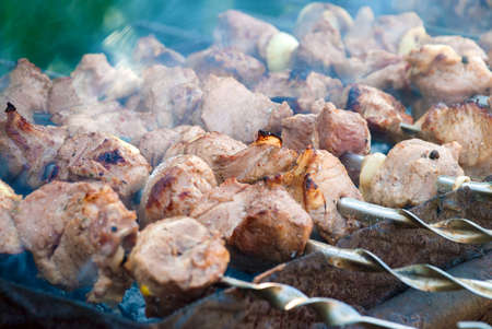 Smoky grilling the marinated pork meat delicious shashlik.の写真素材