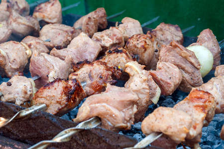 Smoky grilling the marinated pork meat delicious shashlik.の写真素材