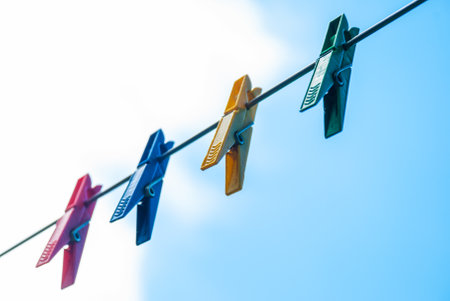 Colorful plastic clothespins on a rope.の写真素材