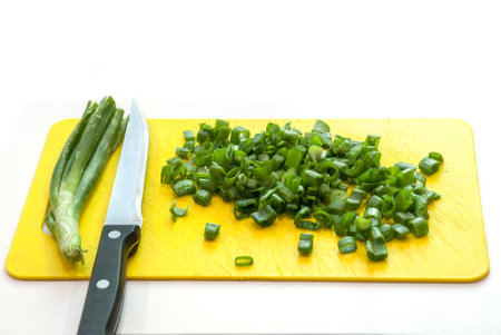 Fresh green onion on the plastic board.の写真素材