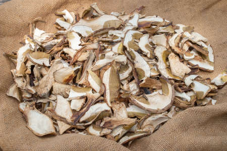 Dried porcini mushrooms on a wooden table. Food background. Rustic style.の写真素材