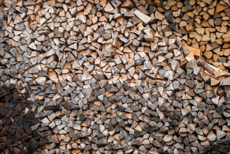 Preparation of firewood for the winter. firewood background, Stacks of firewood in the forest. Pile of firewood.の写真素材
