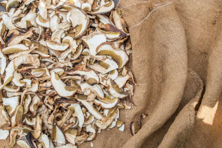 Dried porcini mushrooms on a wooden table. Food background. Rustic style.の写真素材