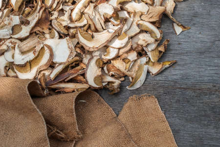 Dried porcini mushrooms on a wooden table. Food background. Rustic style.の写真素材