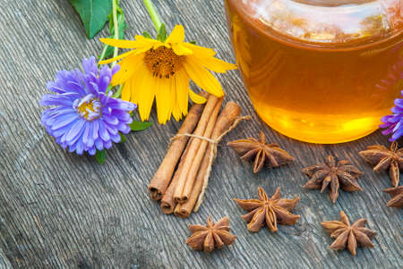 Honey in jar with honey spoon on vintage wooden backgroundの写真素材