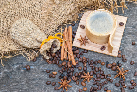 Wooden cup of coffee and coffee beans.