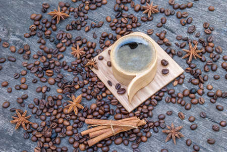 Wooden cup of coffee and coffee beans.の写真素材