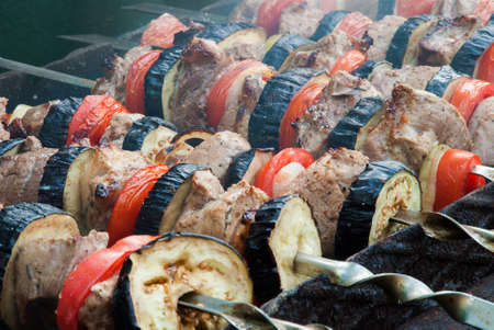 Juicy slices of meat with sauce prepare on fire (shish kebab).の写真素材
