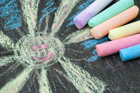 Colored chalk for drawing on a wooden background.の写真素材