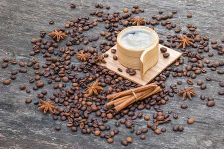 Wooden cup of coffee and coffee beans.の写真素材