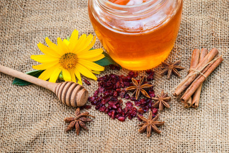 Honey in jar with honey spoon on vintage wooden backgroundの写真素材