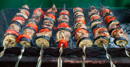 Juicy slices of meat with sauce prepare on fire (shish kebab).の写真素材