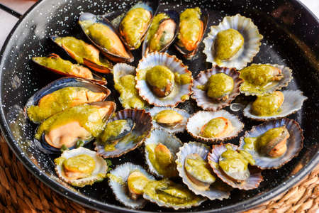 Fried mussels in a pan close up.の写真素材