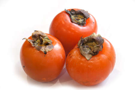 fresh ripe persimmons isolated on white background.の写真素材