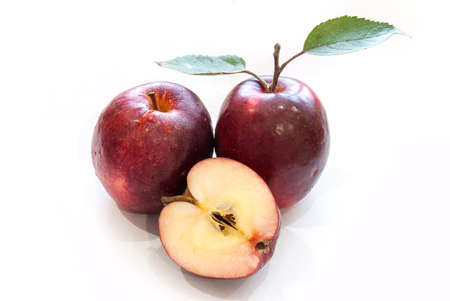 Fresh red apples with leaves isolated on white background.の写真素材