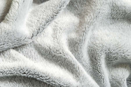 Close up white shaggy artificial fur texture or carpet for background.の写真素材