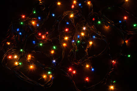 Christmas background with lights. Christmas lights border. Glowing colorful Christmas lights on black background. New Year. Christmas. Decor. Garland.の写真素材