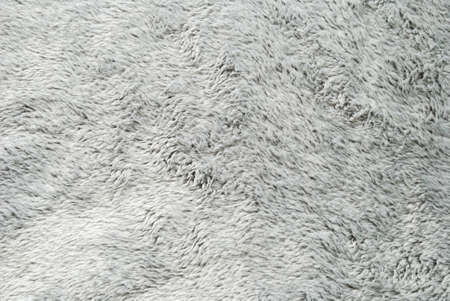 Close up white shaggy artificial fur texture or carpet for background.の写真素材