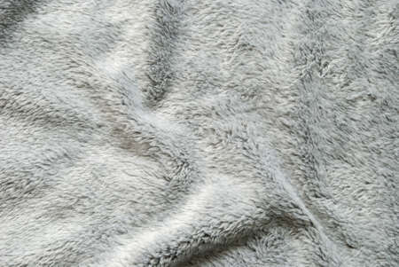 Close up white shaggy artificial fur texture or carpet for background.の写真素材