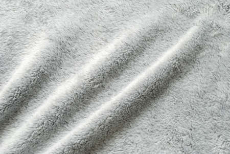Close up white shaggy artificial fur texture or carpet for background.の写真素材