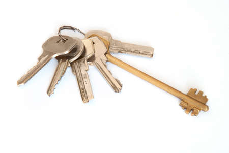 A bunch of modern door keys on ring on white background.の写真素材