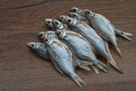 some dried fish on a dark wooden background /