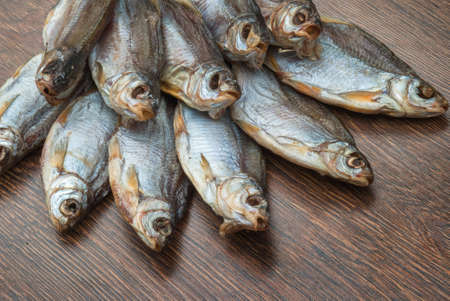 some dried fish on a dark wooden background /の写真素材