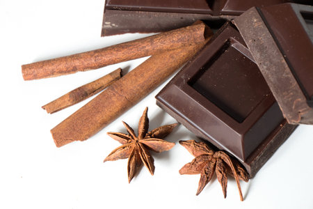 Pieces of Chocolate and cinnamon isolated on white background.