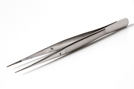 Pair of steel tweezers isolated on white.