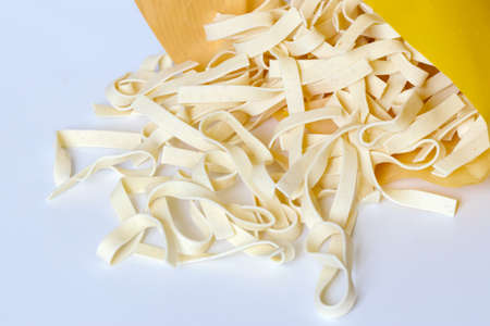 Egg pasta nest isolated on white background, top view