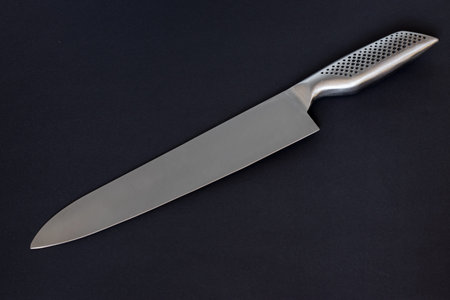 Kitchen knife on darck background.