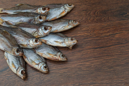 some dried fish on a dark wooden background /