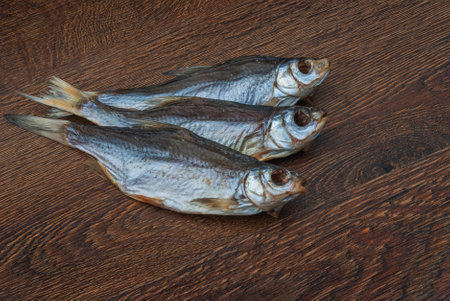 some dried fish on a dark wooden background /の写真素材