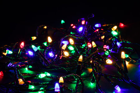 Christmas garland lights on darck background.