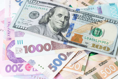 Ukrainian money - 500 hryvnia banknotes USA 100 dollars bills. Finance crisis in Ukraine, the fall of the hryvnia to the dollar exchange rate. Money background /の写真素材