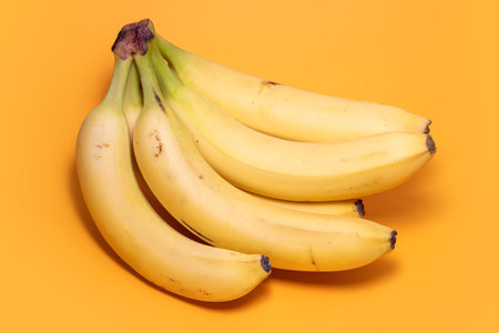 Bunch of bananas on yellow background.の写真素材