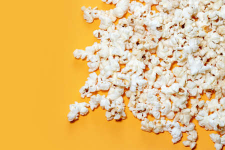 Tasty salted popcorn on yellow backgroundの写真素材