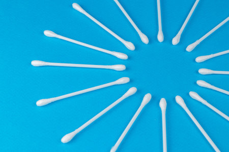 White cotton swabs on blue backgroundの写真素材